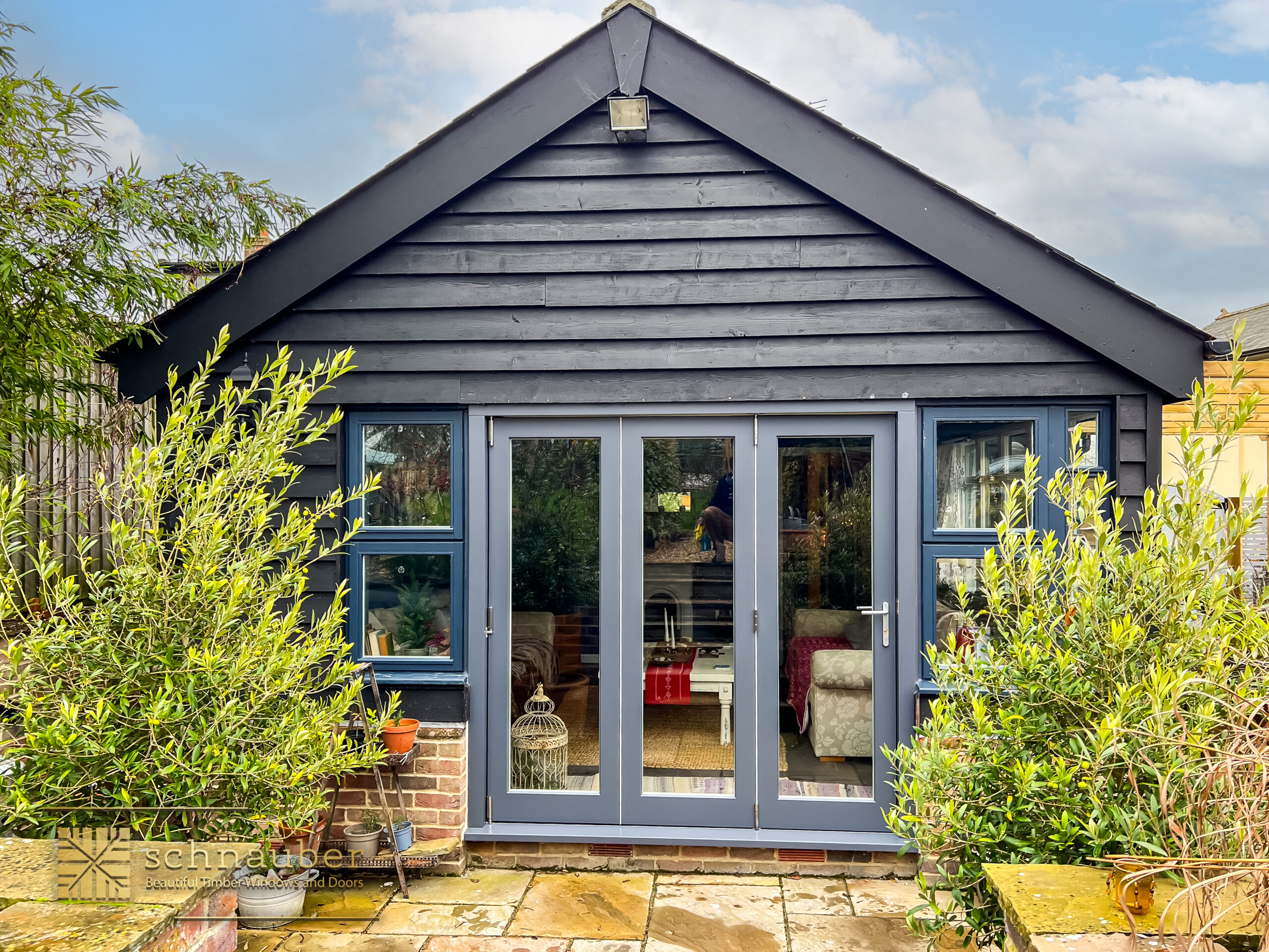 Timber bifold doors Bedford opening to garden