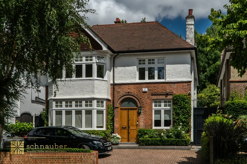 White timber casement windows on a brick house