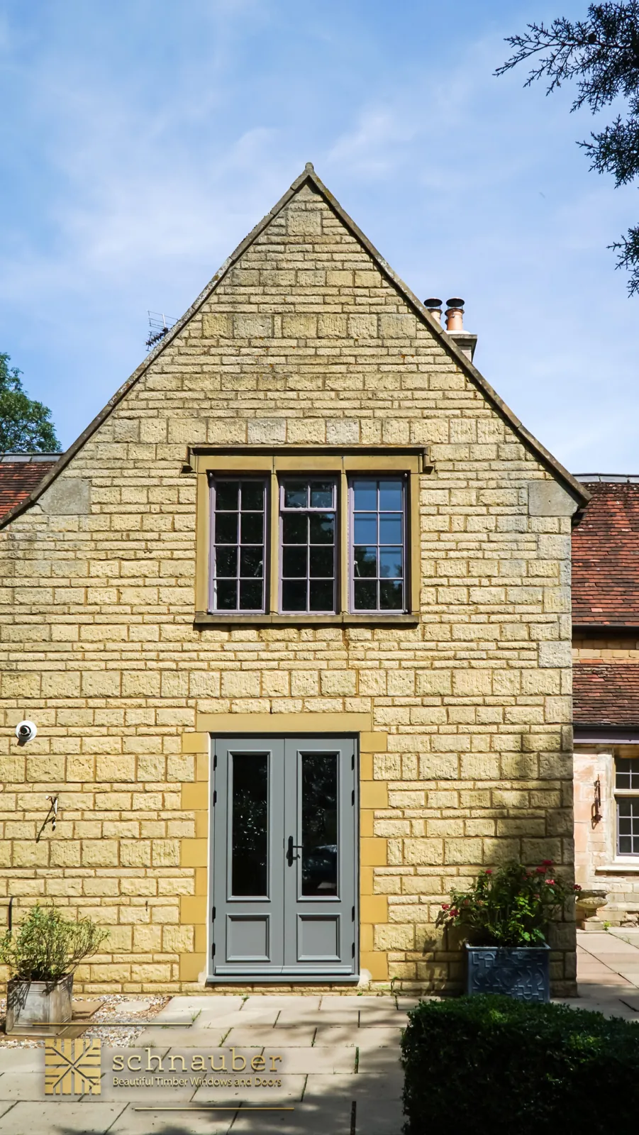 Stone cottage with grey timber French doors